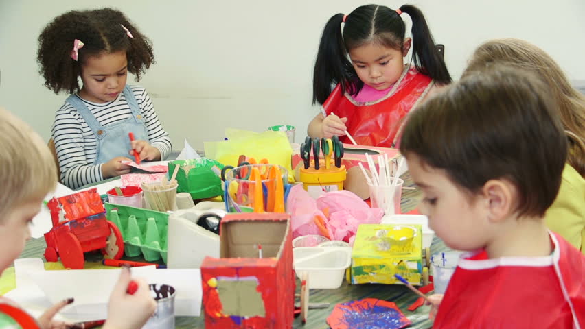Nursery students doing arts and crafts in the classroom with their teachers. Royalty-Free Stock Footage #17913625