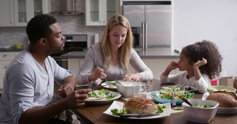 Girl and her mixed race parents dining in their kitchen, shot on R3D