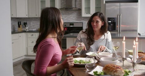Lesbian couple having a romantic dinner in their kitchen, shot on R3D