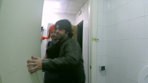 transvestite entering the toilet with a man