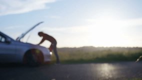 4K Funny clip of blurred man kicking his car in frustration, blurred for text