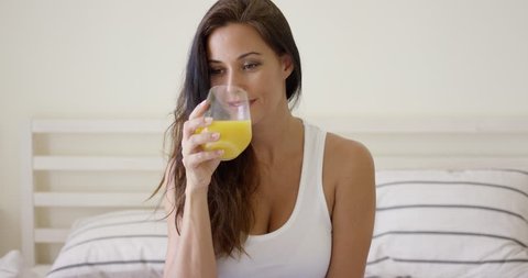 Young woman enjoying a glass of orange juice