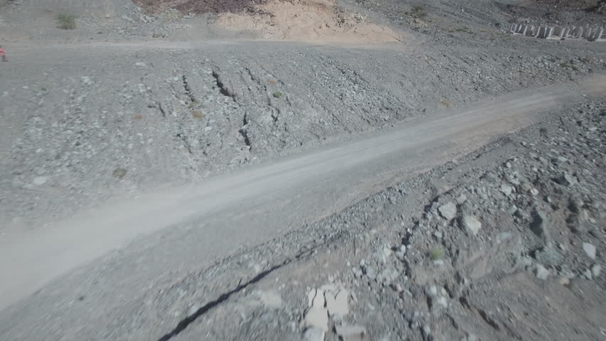Car rally through mountains shot using drone