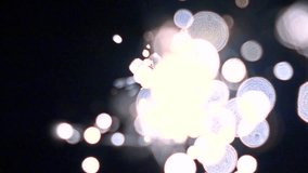 Blue and magenta burning sparkler against dark background. Super slow motion bokeh video
