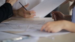 Active discussion of charts and plans on paper with your hands and pencils behind a desk. - Powered by Shutterstock - Get 15% off with code: PIKWIZARD15