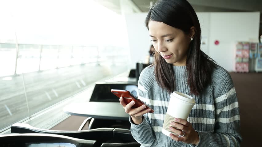 Woman using cellphone and drink with coffee 
