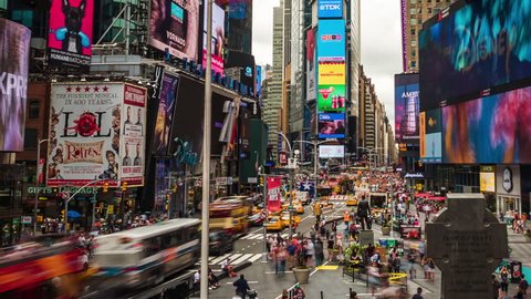 New York, USA - July 5, 2016: Time lapse view of people and traffic at Times Square, famously adorned with billboards and advertisements, in Manhattan, New York City, United States of America.