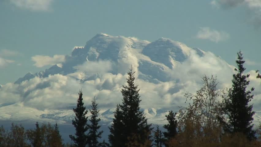 Zoom Out From Mountaintop Covered in Clouds