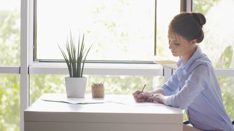 Young Beautiful Woman Draws A Sketch Of The Window In Office