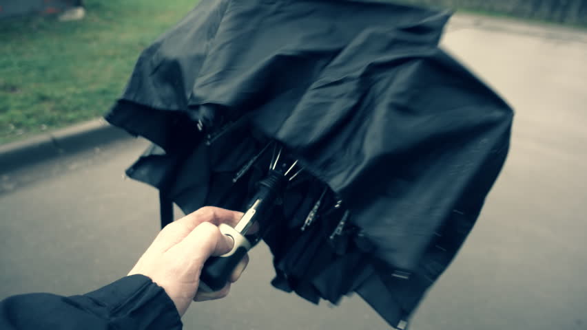 Opening and closing the black automatic umbrella when rain approaching and when rain stops. Slow motion, high speed camera, 250fps