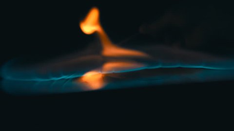 A lit match ignites gasoline. Blue wave at the forefront of fire go to meet. S-log - High Dynamic Range. Slow motion, high speed camera, 250fps