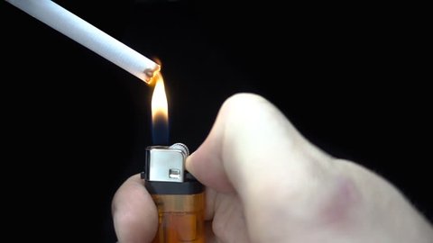Ignite the lighter and light a cigarette. Closeup. S-log - High Dynamic Range. Slow motion, high speed camera, 250fps