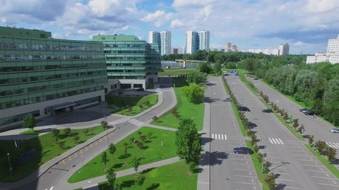 MOSCOW - JUN 13, 2016: Business Park Western Gate with parking place near highway with traffic at sunny summer day. Aerial view