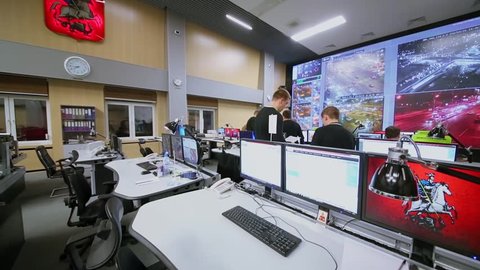 MOSCOW - FEB 04, 2016: People work in operations room with many displays in data center