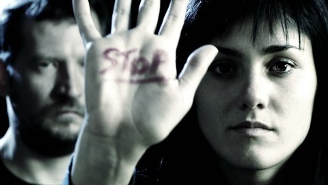 Concept of stop to violence on women with woman and man closeup