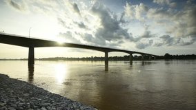 Time Lapse video of Bridge across the Thai-Lao friendship bridge in the sunset with clouds stormy at Nong Khai, Thailand