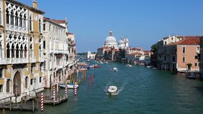 Boats navigating along the Grand Canal in Venice with the Basilica di Santa Maria della Salute in the background in Italy famous city. Shot as a time lapse video. 