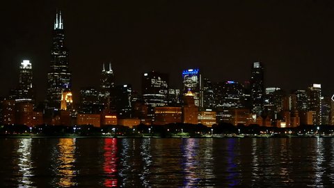 Chicago Skyline Reflected on the Lake at Night Panoramic.
Chicago downtown cityscape reflected on the Michigan lake at nighttime.
Awesome Chicago city skyline.
Colorful illuminated skyscrapers.