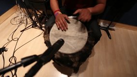 Musicians hands playing folcloric drums at recording studio