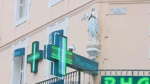 Pharmacy sign with Virgin Mary in Lourdes, France