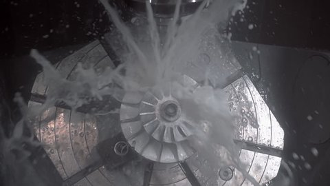 The fluid cools the machined part on a milling machine. Slow motion, high speed camera, 250fps
