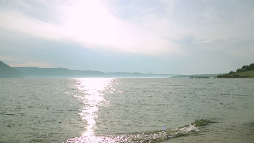 Silhouette of two young women running around and jumping on the sandy beach at sunset. Friendship, summer vacation, holidays, party and people concept - group of smiling teen girls jumping on beach.