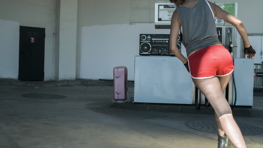 cool rollerskating girl skating dancing and posing in an urban setting