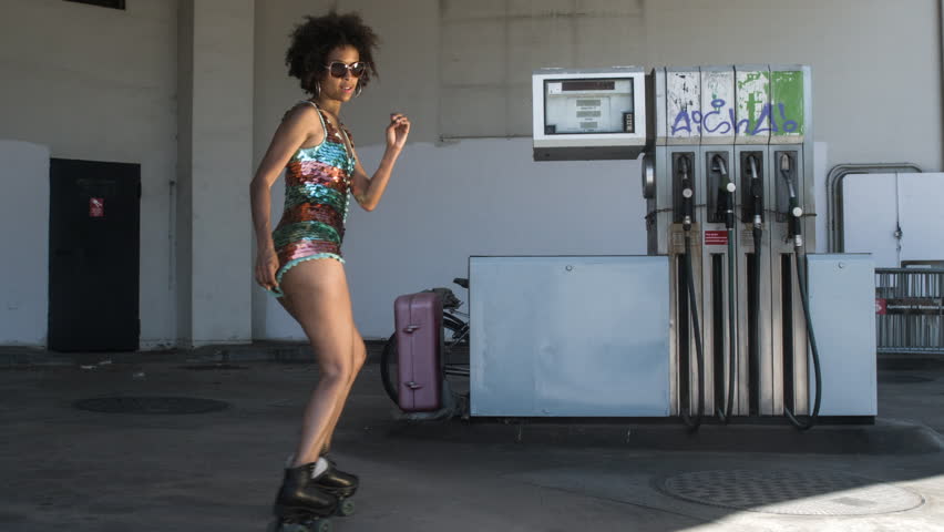 cool rollerskating girl skating dancing and posing in an urban setting