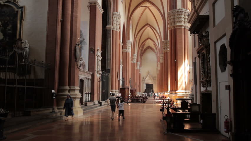 Father and Son walking inside San Petronio cathedral, Bologna.