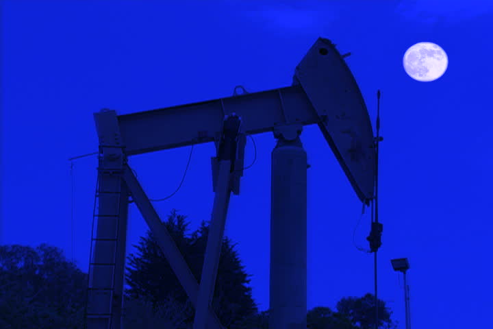 A rig pumping for oil at night.