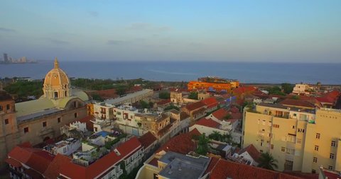 Aerial shot Cartagena, flying over colonial buildings background sea