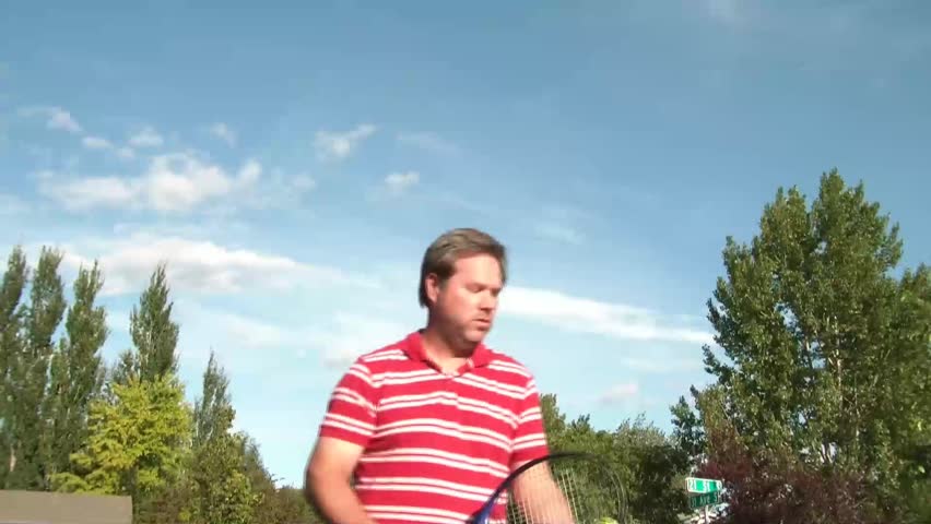 Man Hitting Tennis Ball

