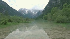 Drone aerial flying over a beautiful mountain lake Landro in Dolomites Alps, Italy