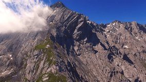 Camera flight over high mountain range. Video from drone. Alpine landscape near Garmisch Paterkirchen in Germany. Amazing places in Central Europe. Destination for hiking, skiing and mountaineering.