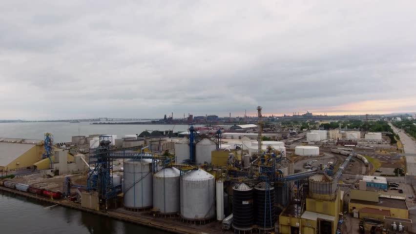 Aerial of factory and industry on lake in Canada. Industrial shipping complex in Ontario Canada. Pollution from industry in Canada.
