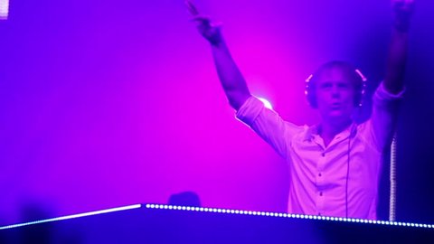 MOSCOW - MAY 6: Popular Dutch DJ Armin Van Buuren on stage with pink blue color light, closeup view on May 6, 2011 in Moscow, Russia.