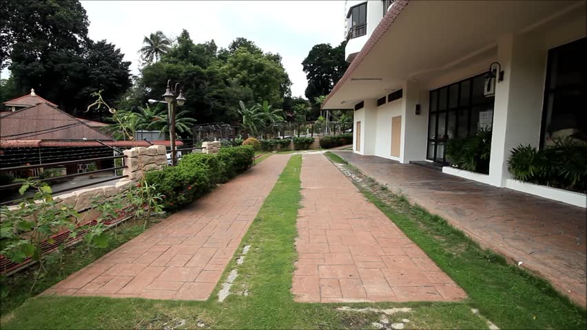 A student with black bag walking away while concentrate playing "Pokemon Go" game