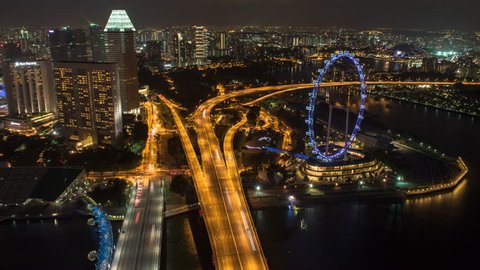 MARINA BAY SINGAPORE, 9 JULY 2016 - Night Aerial Time-lapse of Marina Bay Area Overlooking The Singapore Flyer and Highway