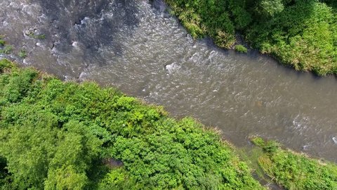 Mountain river and green riverbank from above.