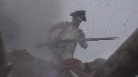 VIRGINIA - OCTOBER 2014 - Reenactment, large-scale, epic American Revolutionary War anniversary recreation -- middle of battle.  Continental Soldiers fire muskets and attack earthworks, explosions.