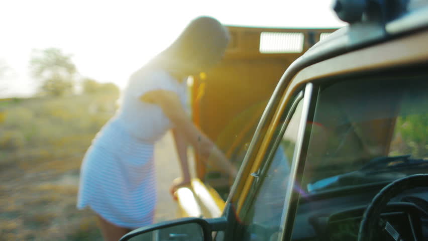 The girl with the faulty car on road