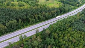 Video drone aerial view over the road in the forest on the way to north of Poland.