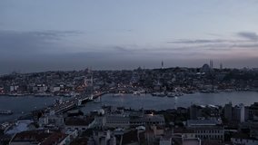 Evening view of the Golden Horn from Galata Tower muezzin singing from the minaret of a mosque. Istanbul, Turkey.
