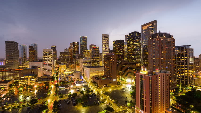 Houston, Texas, USA day to night skyline with stormy skies.