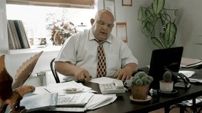 Boss Desk / Manager Office / Boss Doing Nothing / Creative Thinking / No Ideas. Funny fat chief is out of ideas. Man puts the paper sheet aside and begins to dream in the workplace. (av23823c)
