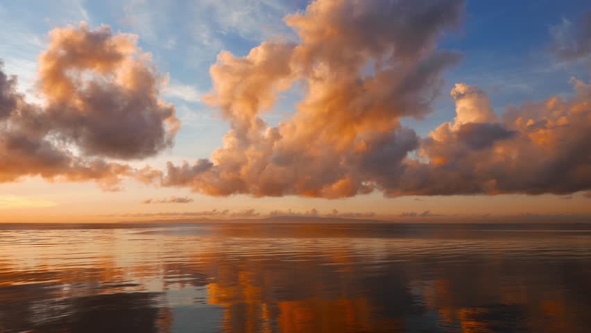 A Dumaguete sunrise video with fiery clouds over the calm ocean. Clouds change color as the sun rises. Presented as time lapse and shot in 4K (Ultra HD) resolution.
 Royalty-Free Stock Footage #18058420
