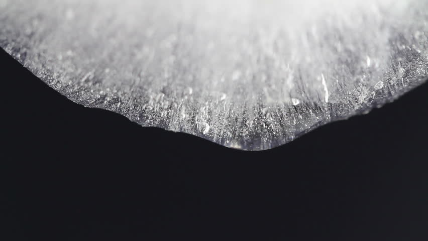 melting ice closeup on black background
