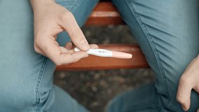 Happy future father hold positive pregnancy test. RAW video record.