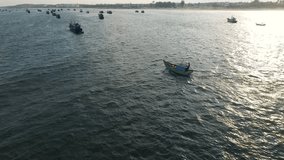 Aerial video over the sea and above a lot of fisherman boats, following a fisherman boat,
Asia, Vietnam, Mui NÃ¨.
