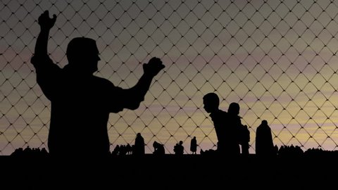 Refugees. Migrants behind barbed wire.